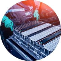 Image of a person working on batteries of an electric vehicle.