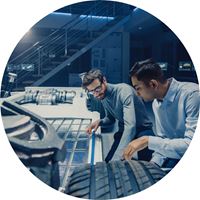 Two automotive engineers are working on a structure for an electric car where the batteries will be located.